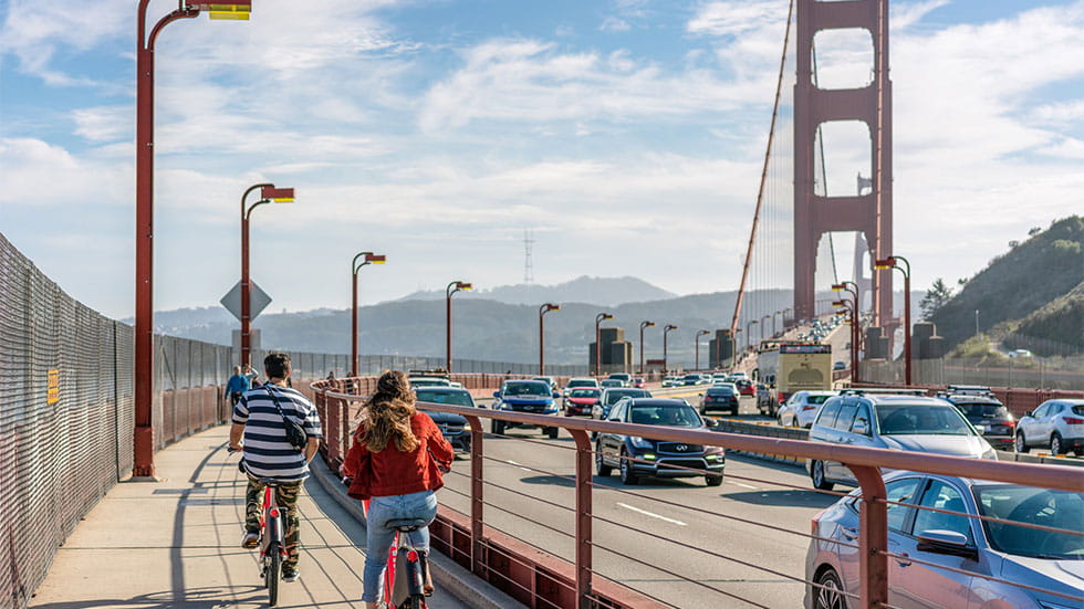 man and woman biking on San Francisco's Golden Gate Bridge