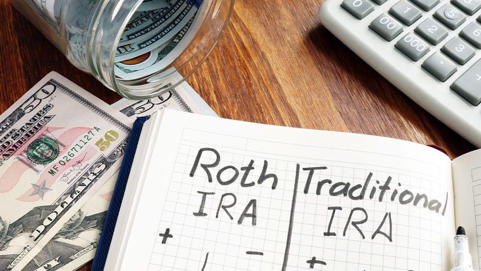 Roth IRA vs Traditional IRA written in notebook