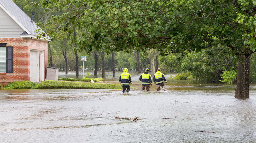  first responders inspect flooded houses