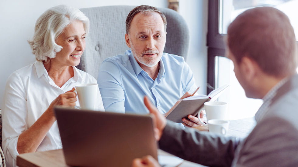 man and woman meeting with insurance agent