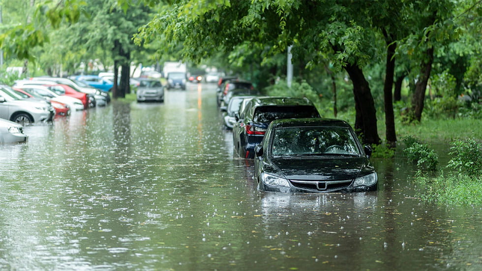 cars parked on flooded street