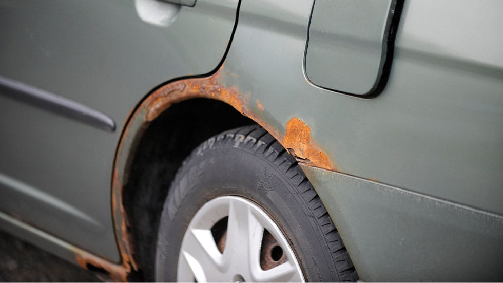 Rust on quarter panel of car near outer wheel well
