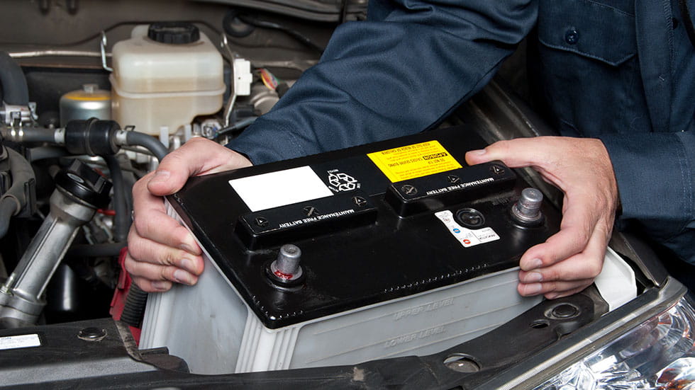 Auto Mechanic Replacing Car Battery