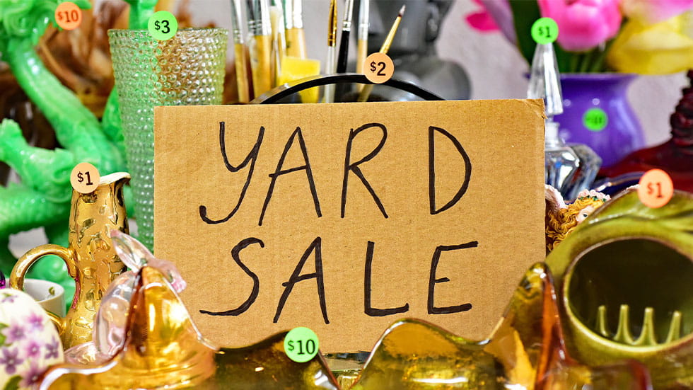 yard sale sign in the middle of items
