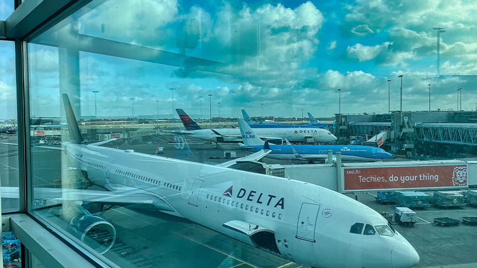 delta plane seen through airport window