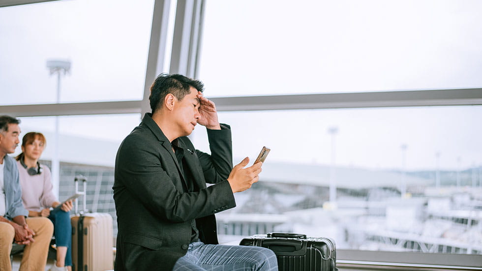 Man realizing his flight is delayed