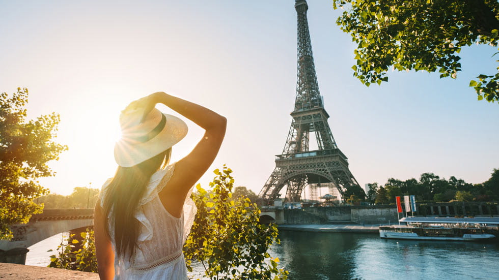Woman looking at Eiffel Tower in Paris, France