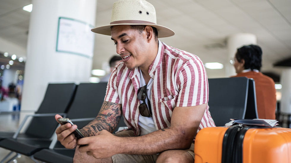 Man sitting in airport on phone