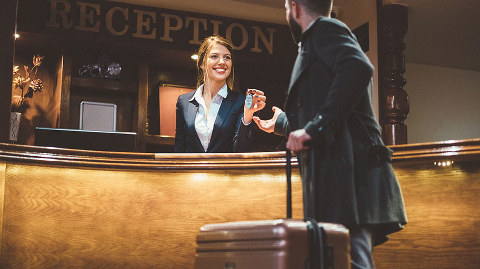 Receptionist Giving Keys to Hotel