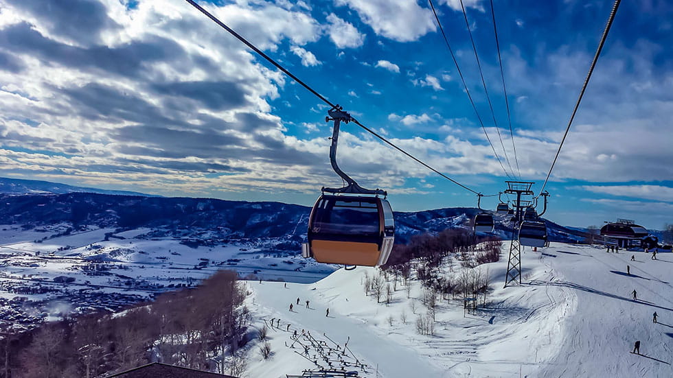 Skiing in Steamboat Springs Colorado passing the Golden Gondola. Photo by Leigh Ann Speake/iStock.com