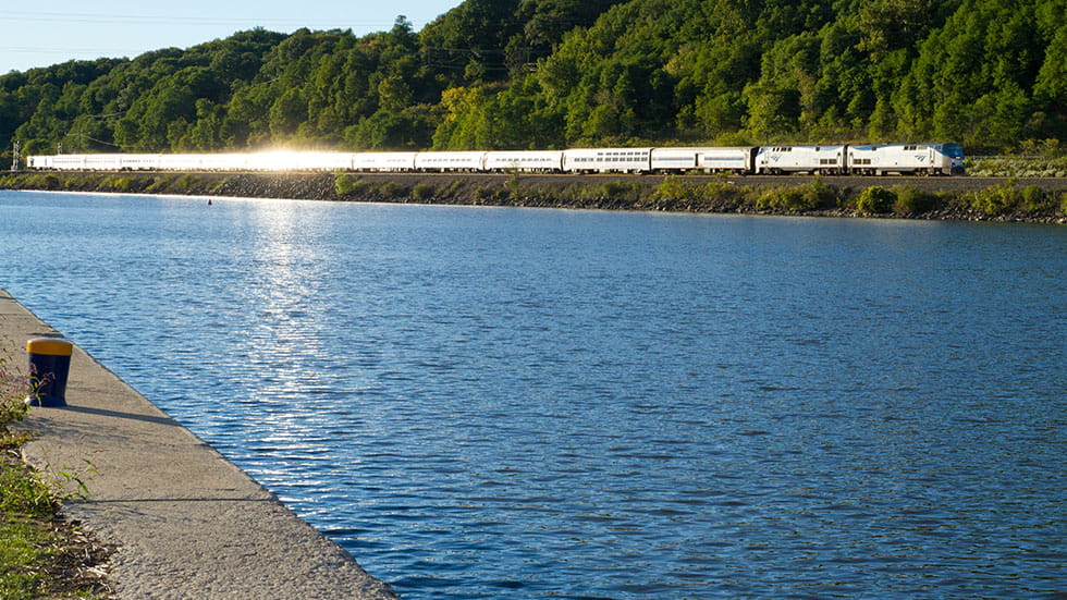Amtrak long distance passenger train along Mohawk river in upstate NY