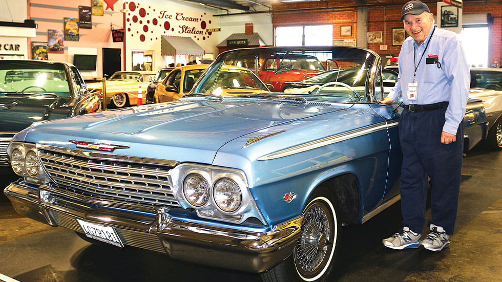 Zimmerman Automobile Driving Museum cofounder Stanley Zimmerman poses with a Chevy Impala convertible.