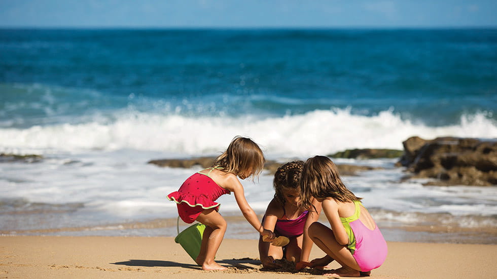 kids on the beach outside Condado Vanderbilt Hotel