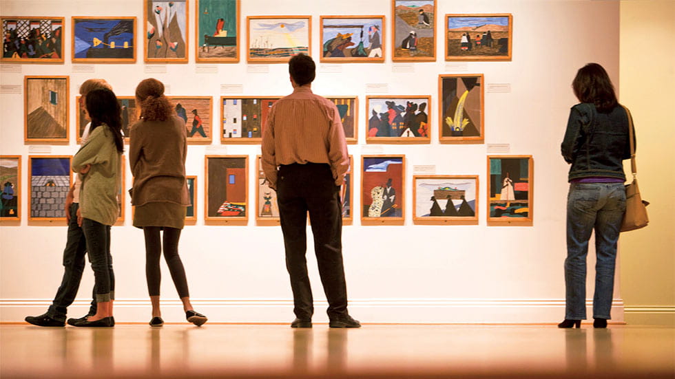 Audience in front of Jacob Lawrence's The Migration Series at The Phillips Collection