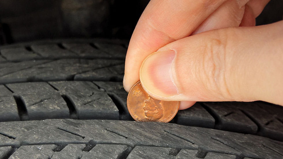 Penny between tire. Photo by JW_PNW/Stock.Adobe.com