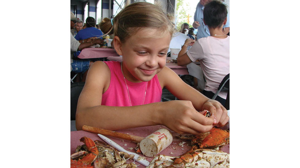 Girl eating crabs in Annapolis, Maryland