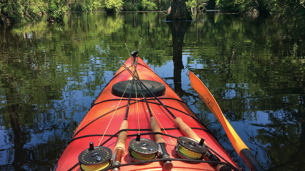 kayak on water with fishing poles