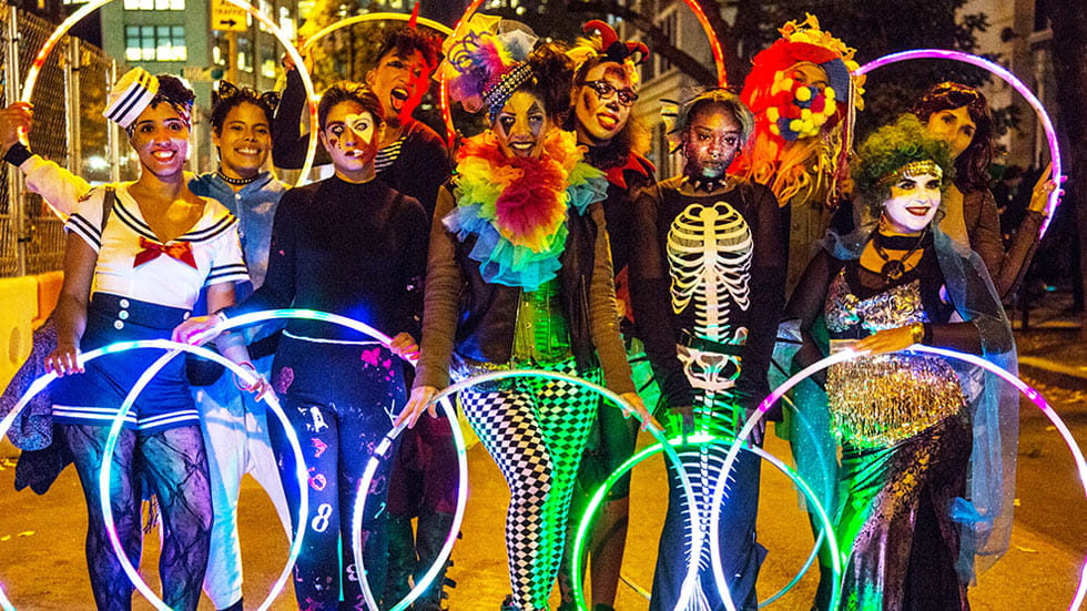 Group of people dressed up for Halloween with glow-in-the-dark hula-hoops