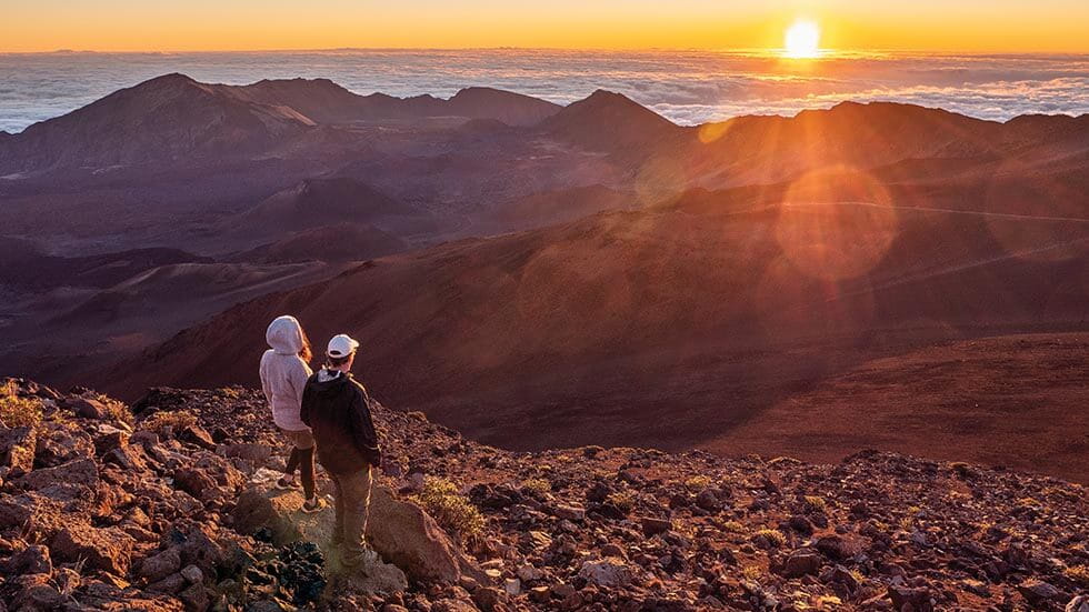 couple checking out the sunrise at Haleakala National Park in Maui Hawaii