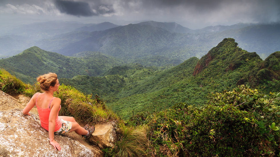 young woman on top of the beautiful jungle of the El Yunque national forest in Puerto Rico