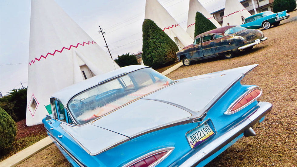 Classic cars parked outside each tipi at the Wigwam Motel along Route 66