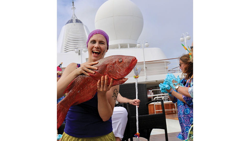 The seafaring tradition of crossing the Equator for the first time involves kissing a fish. Photo courtesy of Renee Sklarew