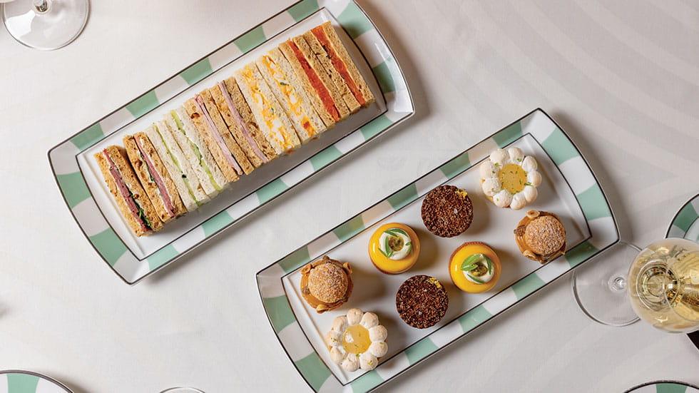 Sandwiches and sweets make a statement on Claridge’s signature striped jade-and-white French porcelain dishes. Photo courtesy of Claridge’s Hotel