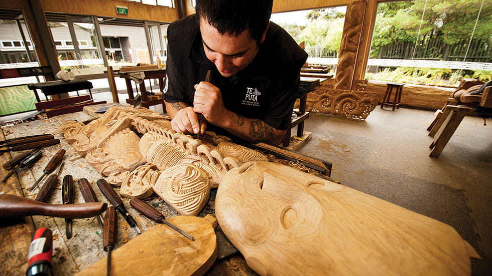 A carver at work at the New Zealand Māori Arts and Crafts Institute. Phot courtesy if Tourism New Zealand