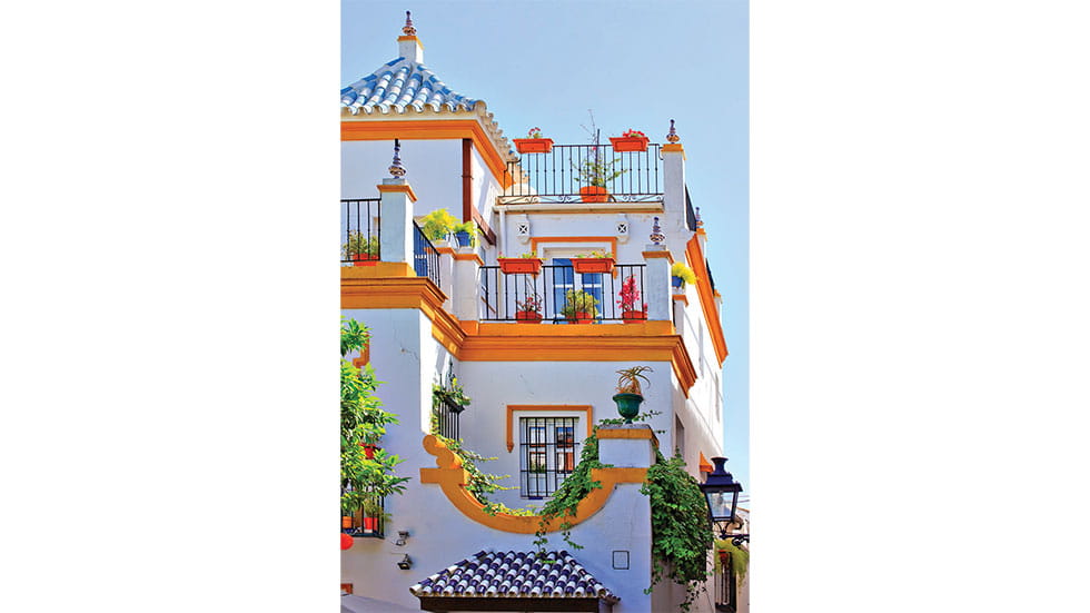 The colorful buildings of Seville’s Santa Cruz neighborhood. Photo by aterrom/Stock.Adobe.com