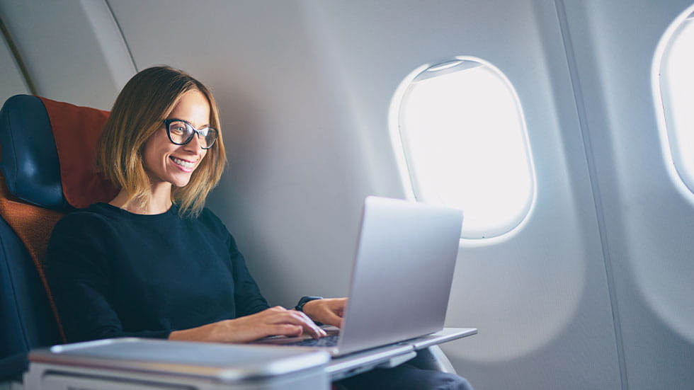 woman on laptop on plane