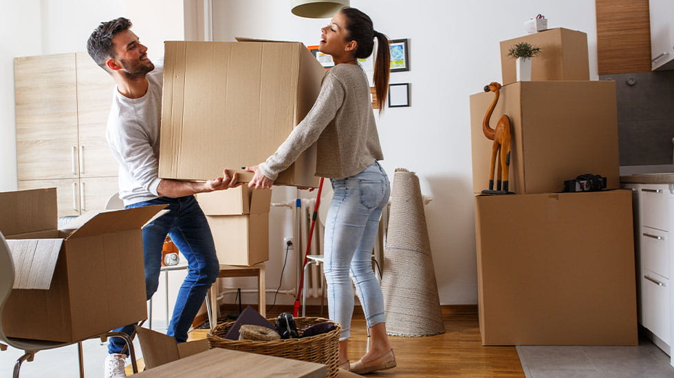 man and woman moving a box together