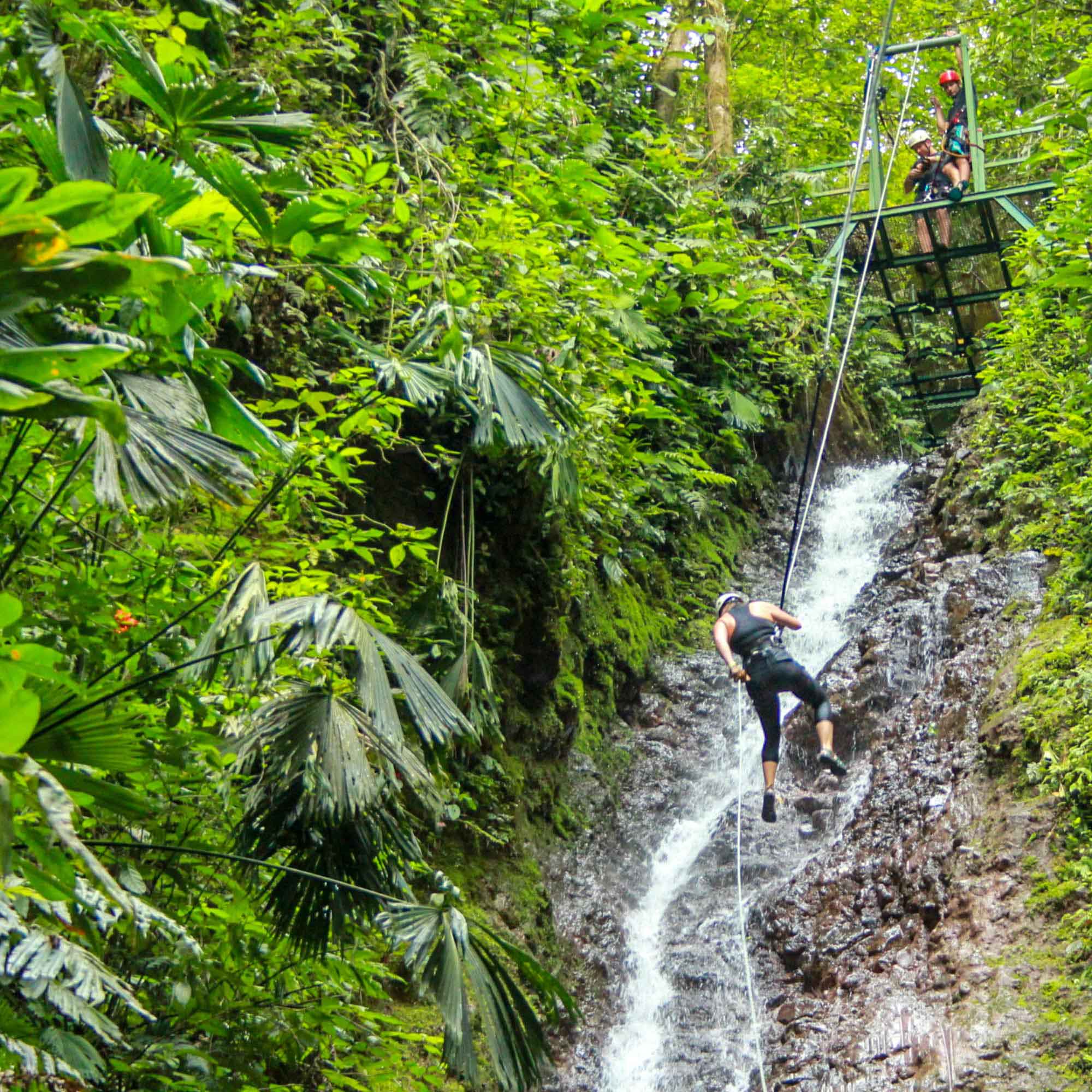 Repelling down water fall in a Costa Rican rainforest