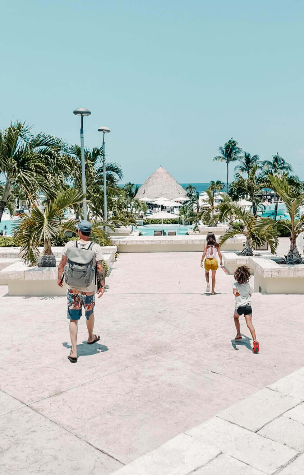 Father and two children exploring all-inclusive resort in Mexico
